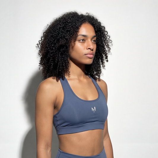 Woman wearing a blue sports bra with a logo on a white background