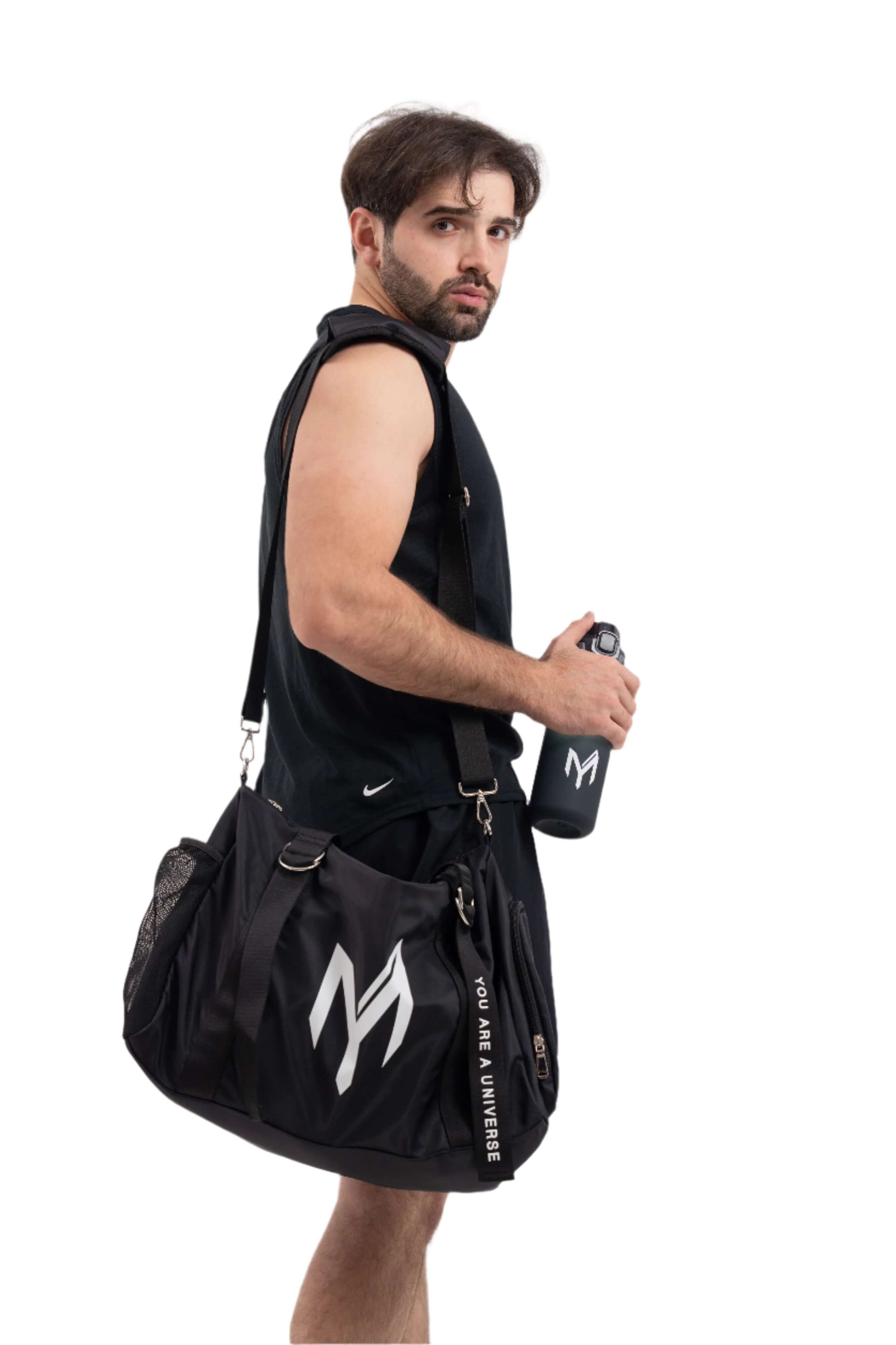 Man holding a black gym bag with a logo on a white background