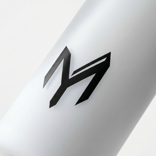 Myticos M monogram detail on white bottle - studio macro