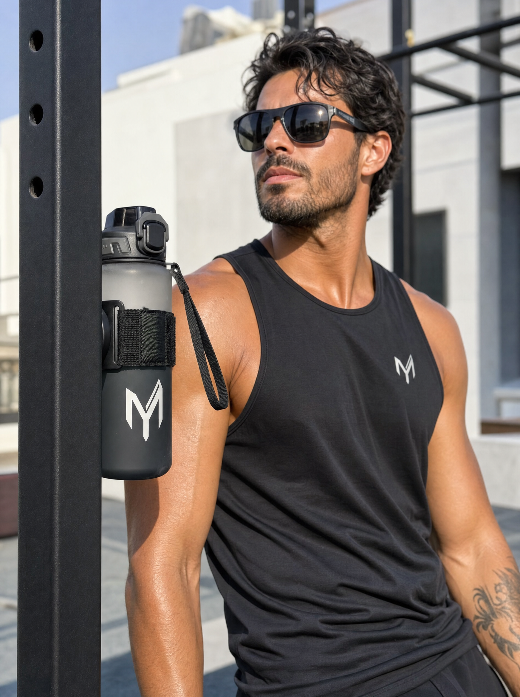 Myticos magnetic holder in use - bottle mounted hands-free to a metal gym rack