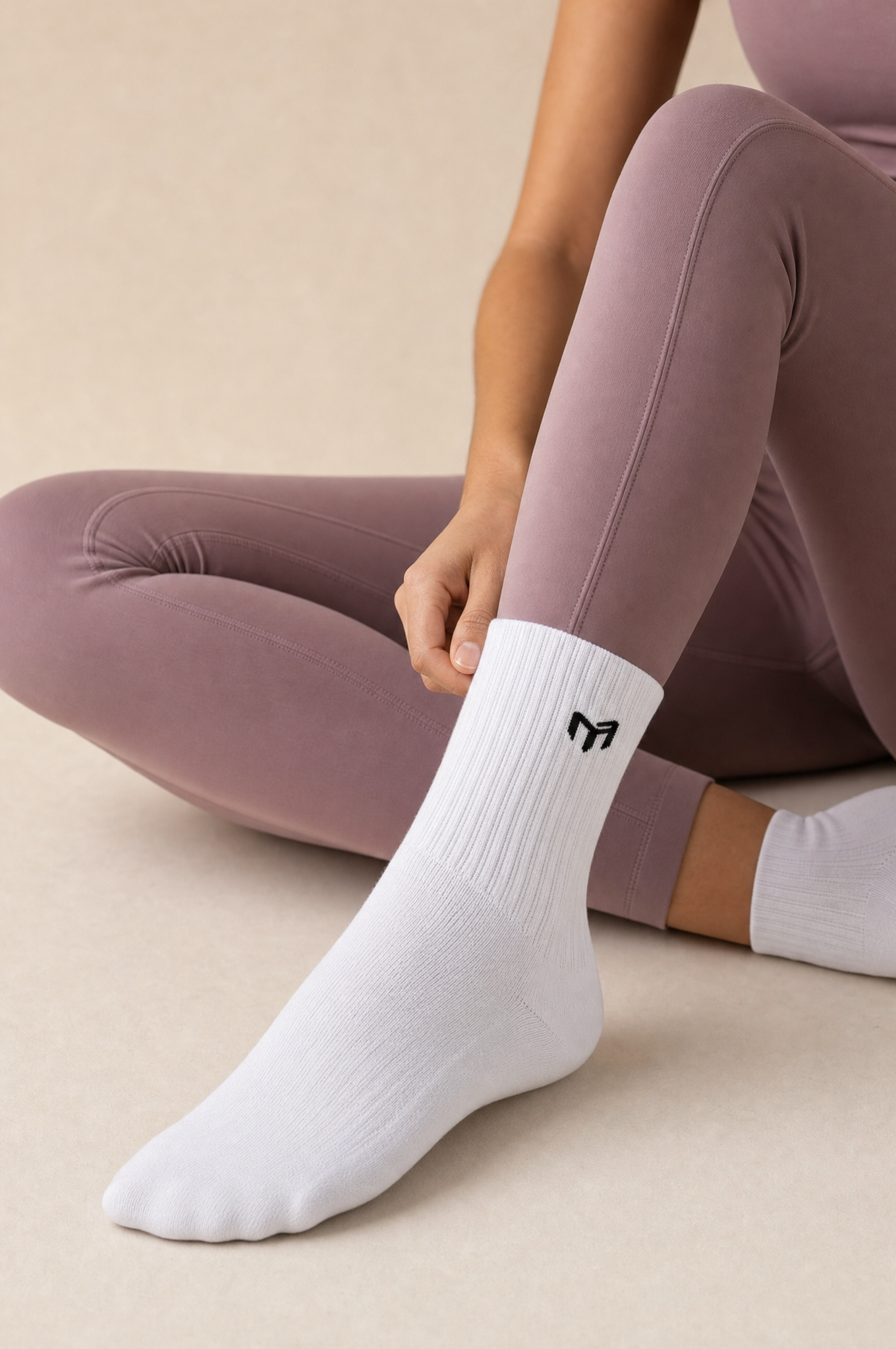 Myticos white crew socks with M logo - lifestyle, seated with leggings