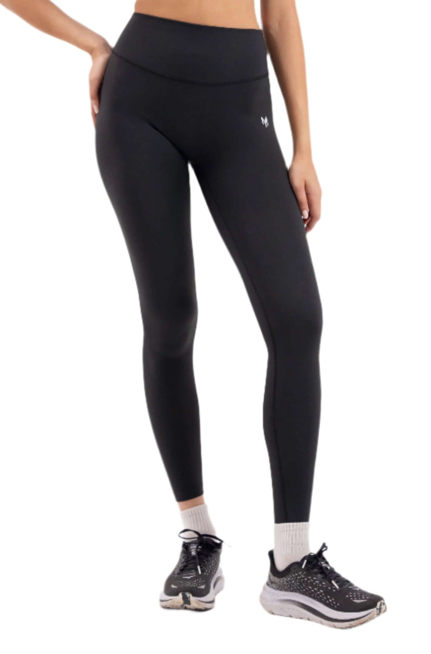 Front view of woman wearing Myticos®️ black sports bra and leggings set, designed for activewear with a sleek, supportive fit against a white background.